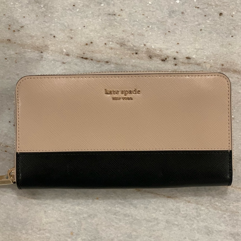 Kate Spade light pink wallet never used with tags, purchased for $188